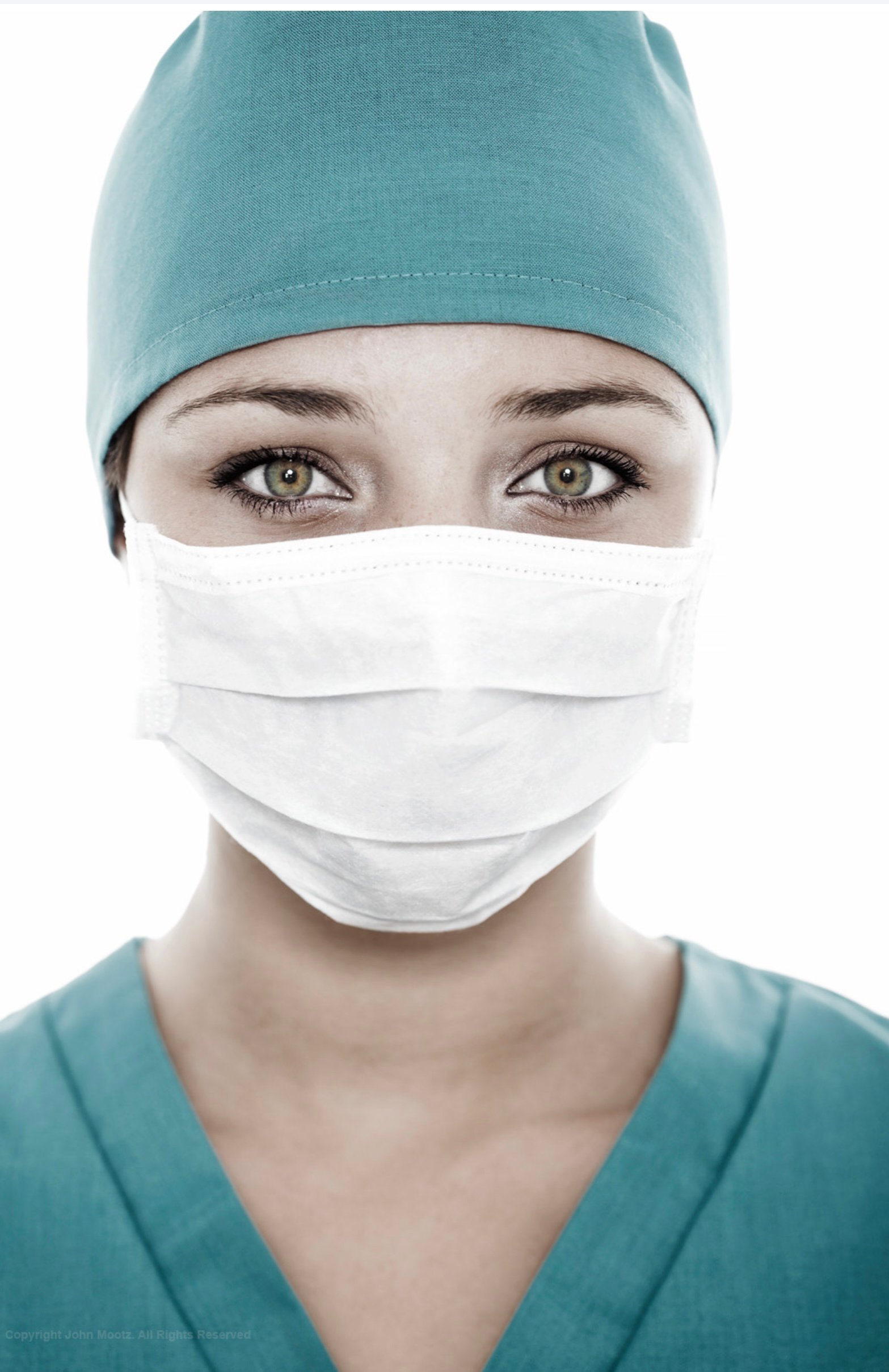 Female healthcare worker in surgical mask and scrubs during a commercial photo shoot in Seattle, captured to honor frontline medical professionals. Makeup by Indigenous Seattle makeup artist Isaac Meyers.