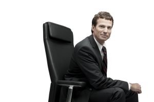 Men’s grooming by Seattle makeup artist Isaac Meyers featuring matte skin and textured hair for corporate headshots.
