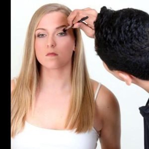 Professional makeup artist applying foundation in Seattle studio